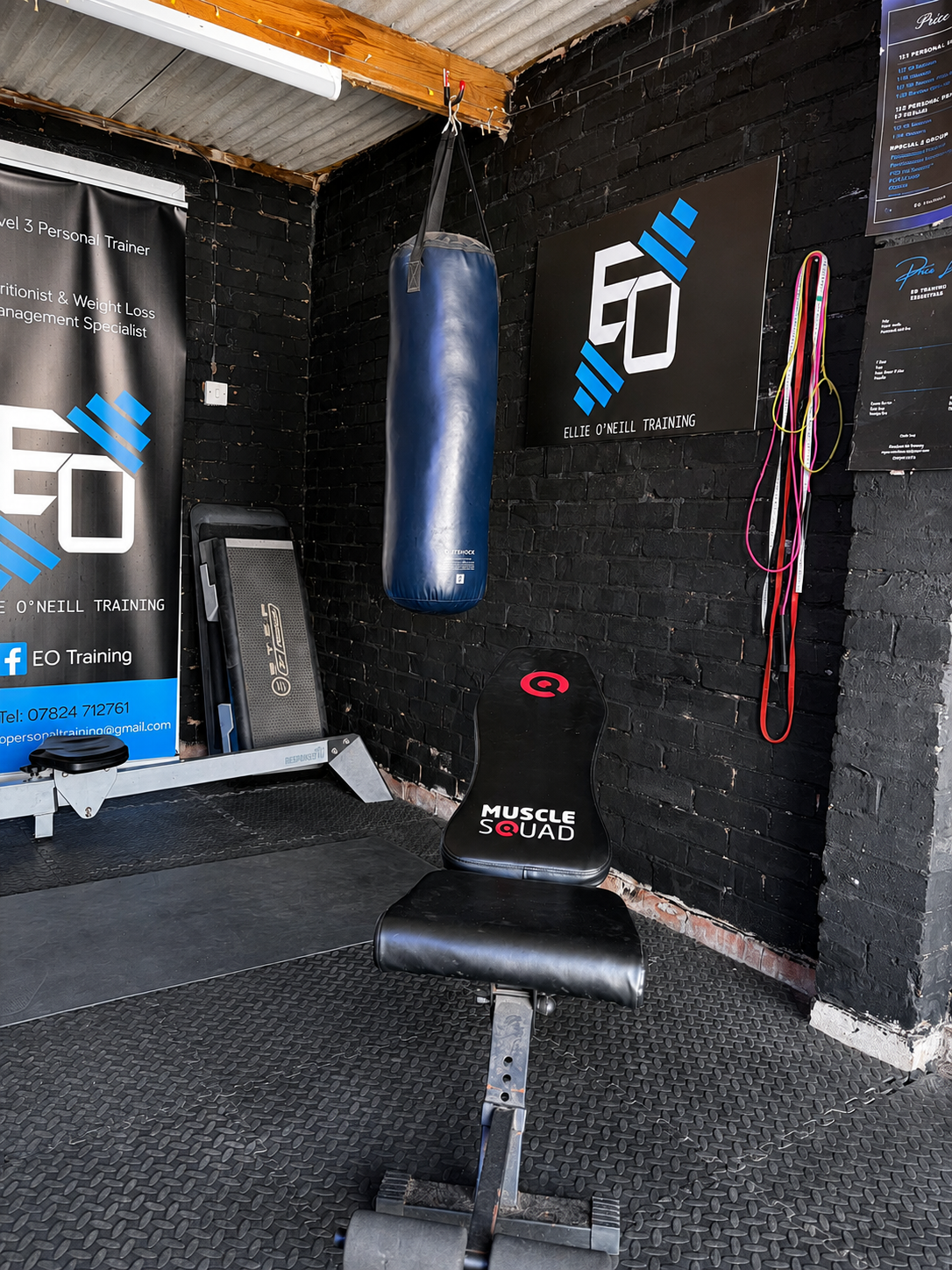 Bench, punch bag and Level 3 personal trainer banner inside EO Training